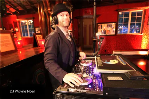 DJ Wayne Noel at the decks inside the red-walled Long Branch Saloon in Half Moon Bay