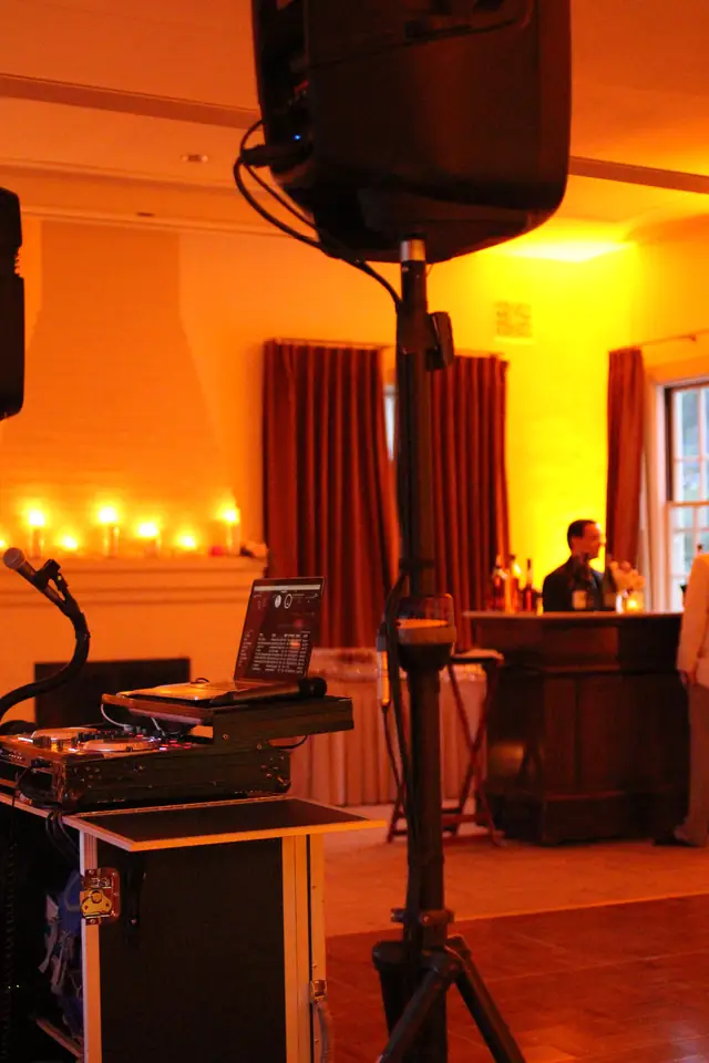 DJ speaker on a stand beside the booth and candlelit fireplace in the amber-lit room at Cavallo Point