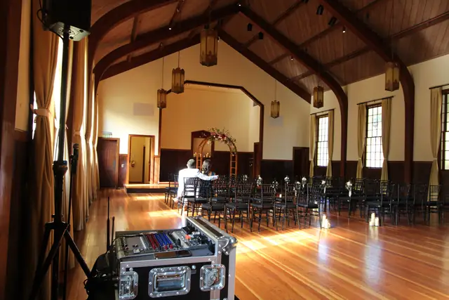 Ceremony setup with mixer and speaker in the wood-beamed hall at Cavallo Point