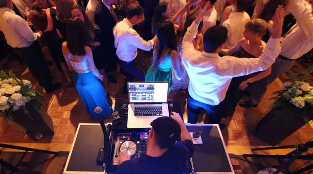 Guests dancing on the parquet floor in front of DJ Wayne Noel's booth at Cavallo Point, seen from above