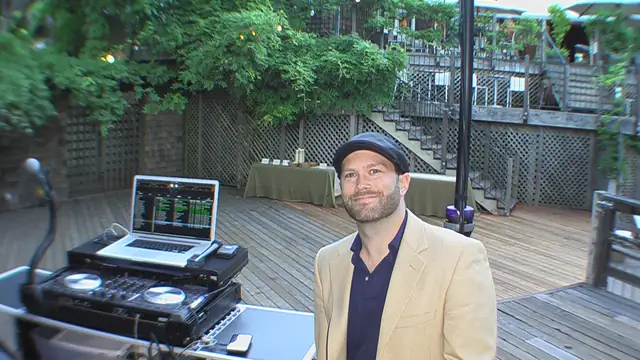 DJ Wayne Noel next to his DJ setup on the wooden back deck at Dawn Ranch Lodge