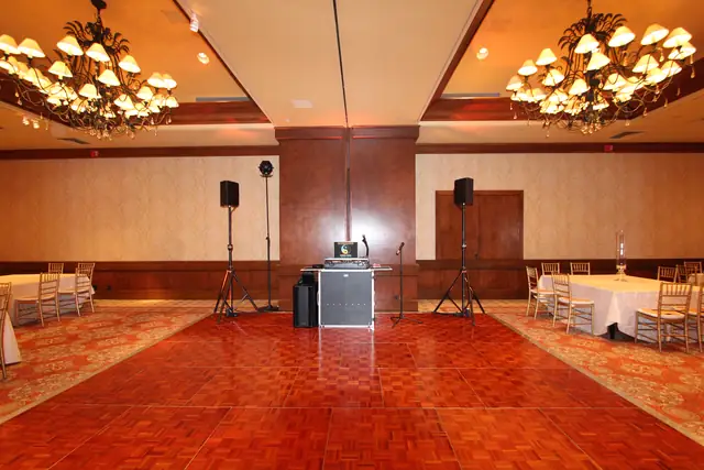 Wayne Noel's DJ booth and speakers set up on the parquet dance floor in the ballroom at the Inn at Spanish Bay, Pebble Beach