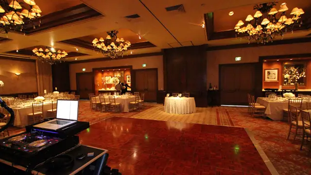 DJ controller and laptop at the edge of the parquet dance floor in the Inn at Spanish Bay ballroom