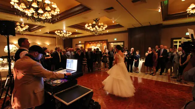 Wedding first dance on the ballroom floor at the Inn at Spanish Bay with Wayne Noel at the DJ controller