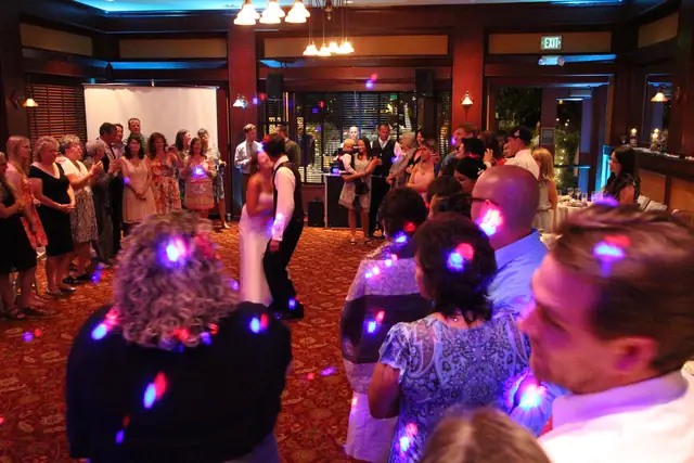First dance at an Inn Marin wedding reception with guests circled around and DJ Wayne Noel's speakers and blue uplighting behind