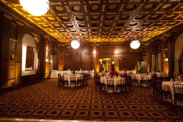 Open carpeted floor and set dinner tables inside the Julia Morgan Ballroom in San Francisco