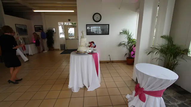 Wedding cake display on a draped table in the entry area of Mavericks House
