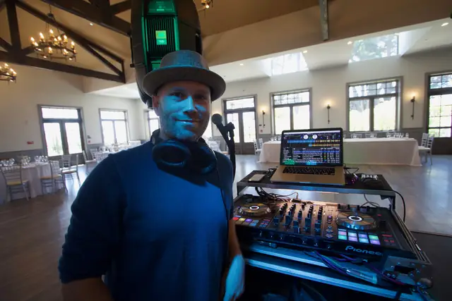DJ Wayne Noel at his controller in the rustic beamed event room at Oceano Hotel and Spa in Half Moon Bay