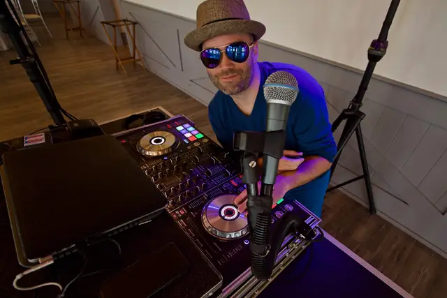 DJ Wayne Noel in a fedora and sunglasses at his controller at Oceano Hotel and Spa