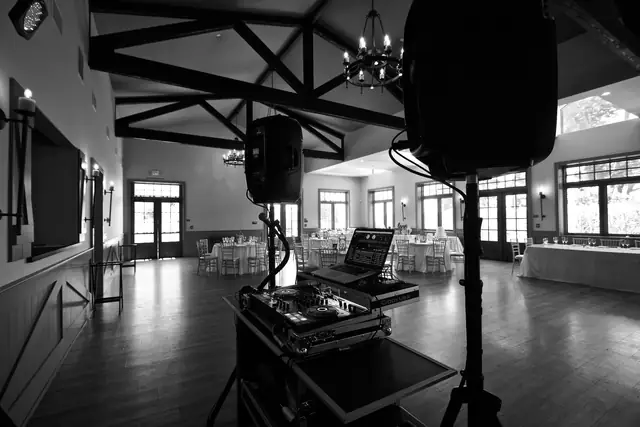 Black and white view from behind the DJ setup into the beamed event room at Oceano Hotel and Spa
