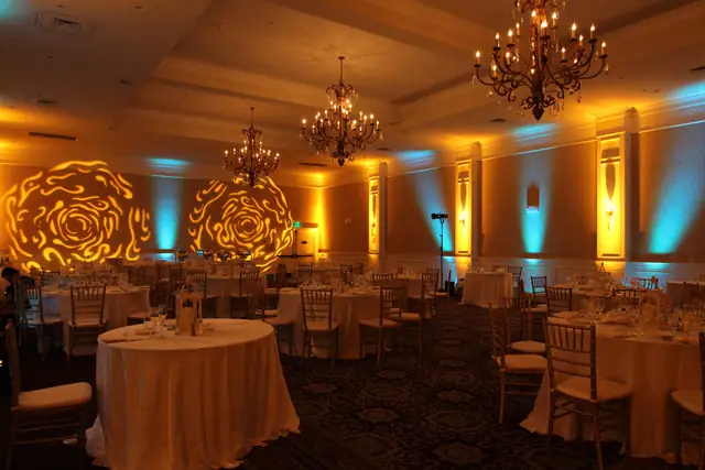 Oceano Hotel and Spa ballroom with amber and teal uplighting and rose patterns on the wall