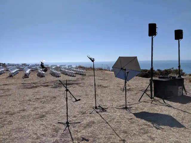 Ceremony chairs, microphones and speakers set up on the bluff above the ocean at Slide Ranch