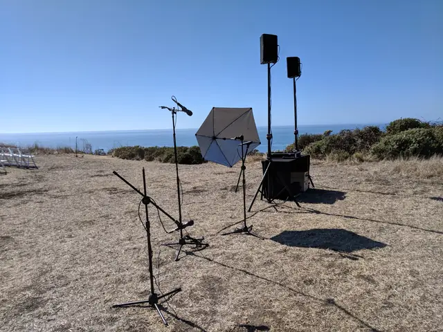 Ceremony sound setup with mics and speakers on the grassy bluff above the ocean at Slide Ranch