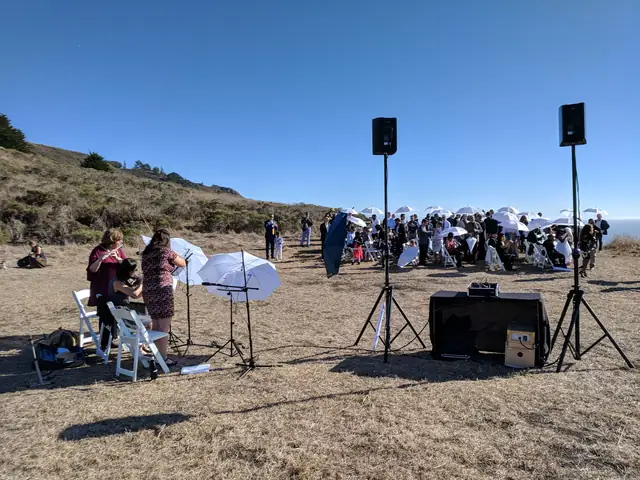 Guests and musicians at an outdoor ceremony at Slide Ranch with DJ speakers on stands