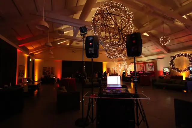 DJ Wayne Noel's sound system and controller set up under lit twig orbs in the event hall at Solage, Calistoga
