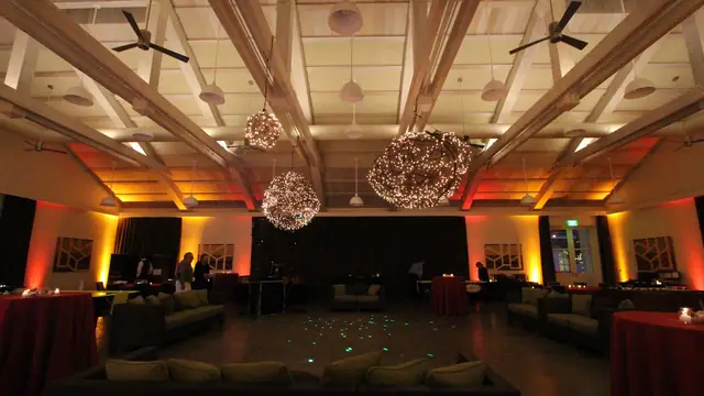 Solage event hall in Calistoga with amber and red uplighting and a dance floor at center