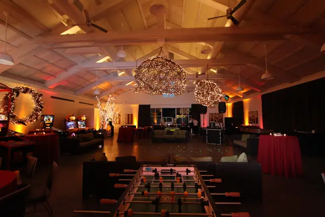 Solage event hall set with lounge seating, games, amber uplighting and DJ Wayne Noel's booth