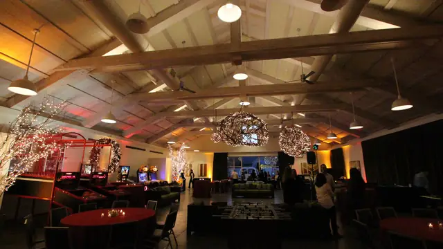 Guests arriving in the Solage event hall with arcade games, lit orbs and amber uplighting