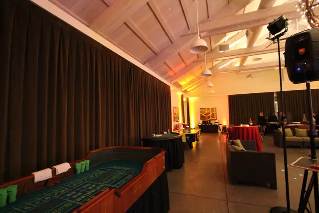 Casino tables and DJ Wayne Noel's speaker along the wall of the Solage event hall