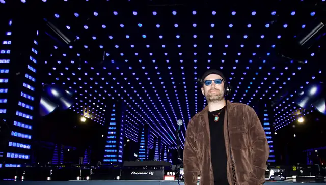 Wayne Noel beside his Pioneer DJ setup under the blue LED ceiling at Temple nightclub, San Francisco