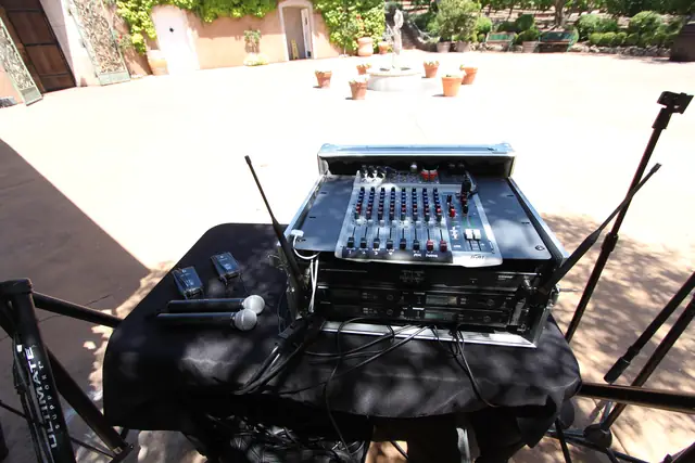 Wireless microphones and mixer on a table overlooking the open courtyard and fountain at Viansa Winery