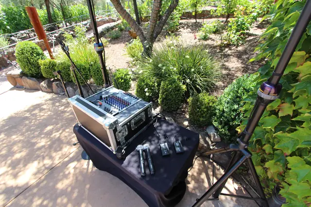 DJ mixer and wireless microphones set up on a garden path overlooking the vineyard terraces at Viansa Winery