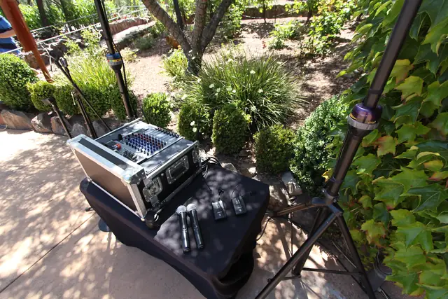 DJ mixer and wireless mics on a table beside the garden beds at Viansa Winery