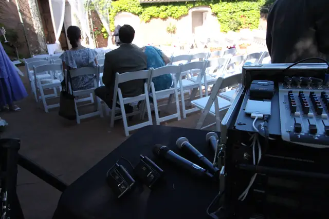 Wireless mics and mixer beside the white ceremony chairs in the courtyard at Viansa Winery