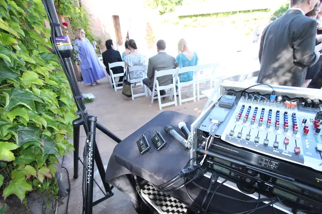 DJ table beside the ivy wall with the ceremony chairs laid out in the courtyard at Viansa Winery