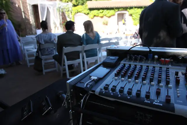 Wedding ceremony chairs in the ivy-walled courtyard at Viansa Winery, seen from behind Wayne's sound mixer
