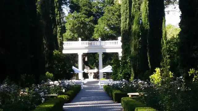 White garden pavilion at the end of the rose garden path at Villa Montalvo, set up for a ceremony